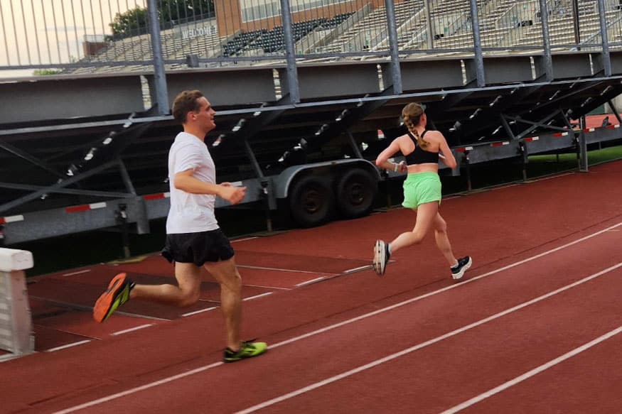 Man and woman running on a track